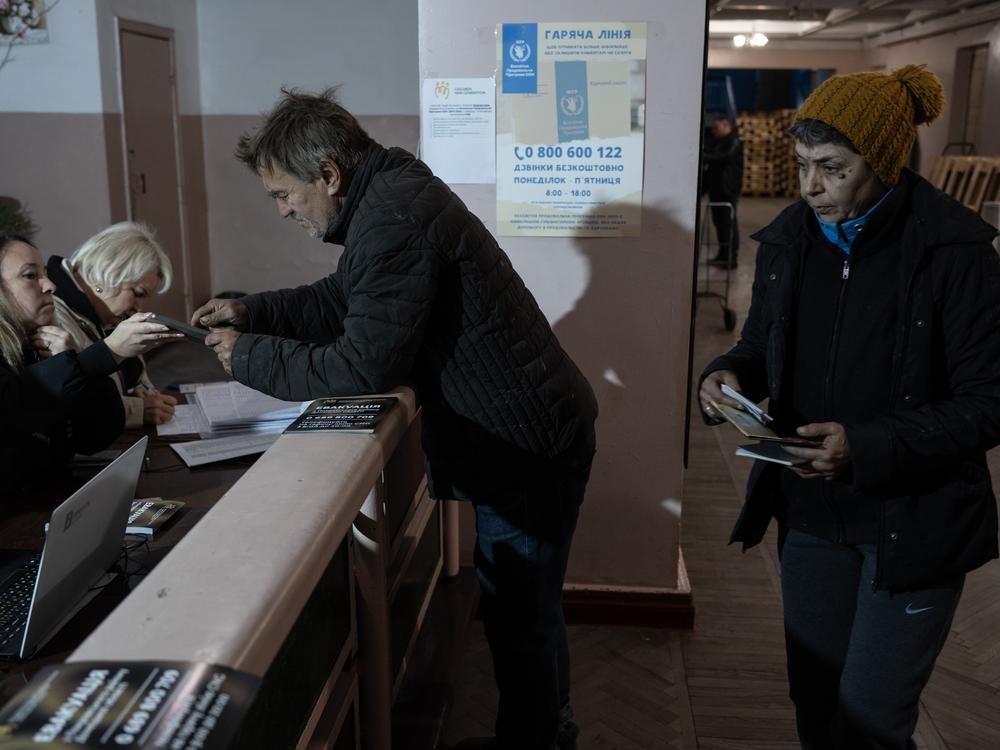 People register to receive humanitarian aid in the battered coal mining town of Dobropillya, Ukraine, on Oct. 17.