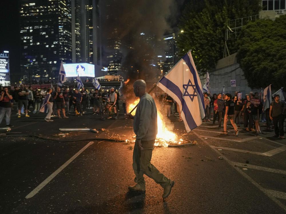 Israelis light a bonfire during a protest after Prime Minister Benjamin Netanyahu dismissed his popular defense minister, Yoav Gallant, in Tel Aviv, Israel, Tuesday.