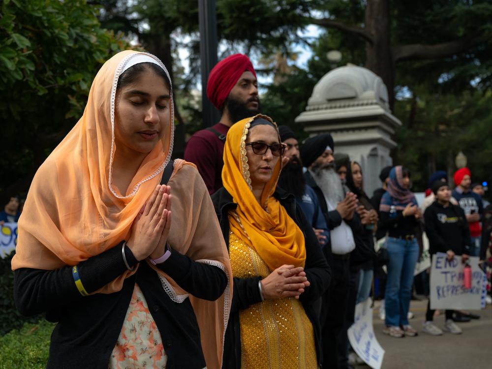 Members of the Sikh community pray at the closing event at the California State Capitol after a march building awareness around fears they'll be targeted in attacks by Indian officials.