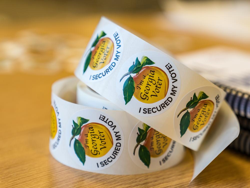 Stickers sit on a table at a polling location on November 8, 2022 in Atlanta, Georgia.