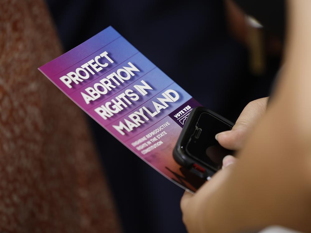 An audience member holds a brochure on abortion rights as Vice President Kamala Harris delivers remarks on reproductive rights at Ritchie Coliseum on the campus of the University of Maryland on June 24, 2024 in College Park, Maryland. Harris is speaking on the two year anniversary of the Dobbs decision, the Supreme Court ruling that overturned Roe v. Wade and struck down federal abortion protections.