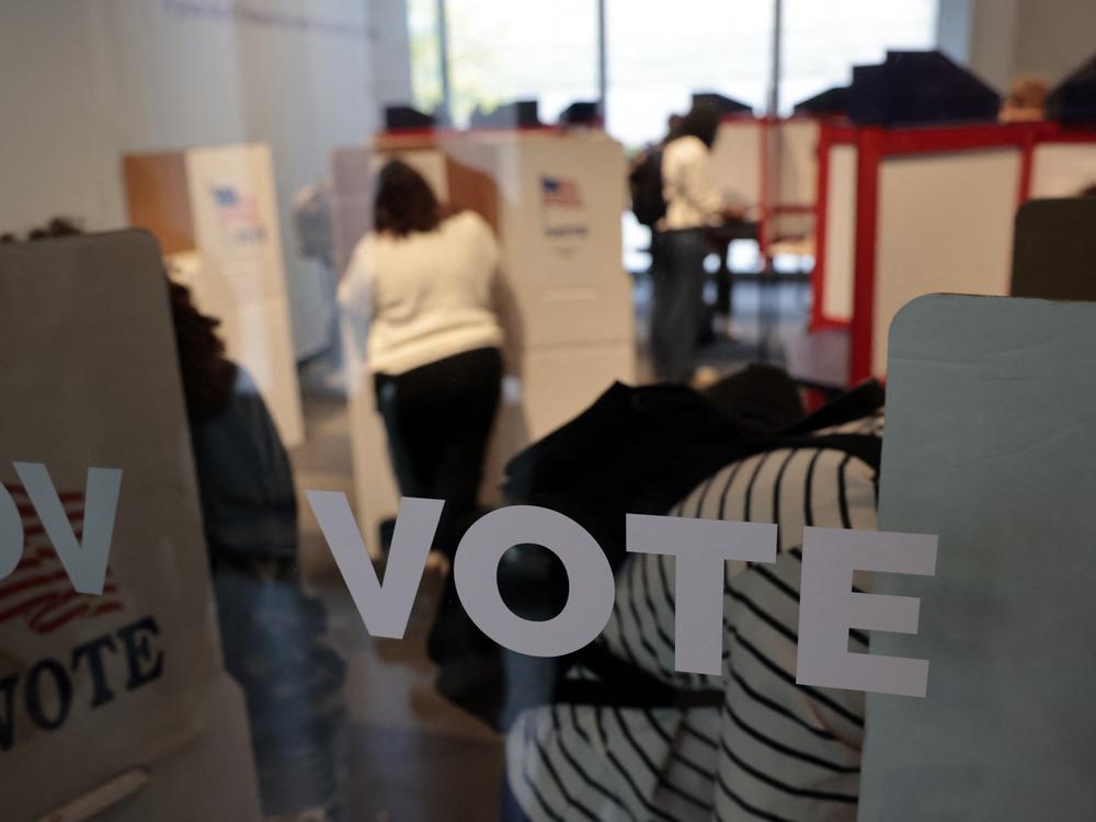 People cast their in-person early ballots for the 2024 general election at a polling station in Ann Arbor, Mich., on Thursday.
