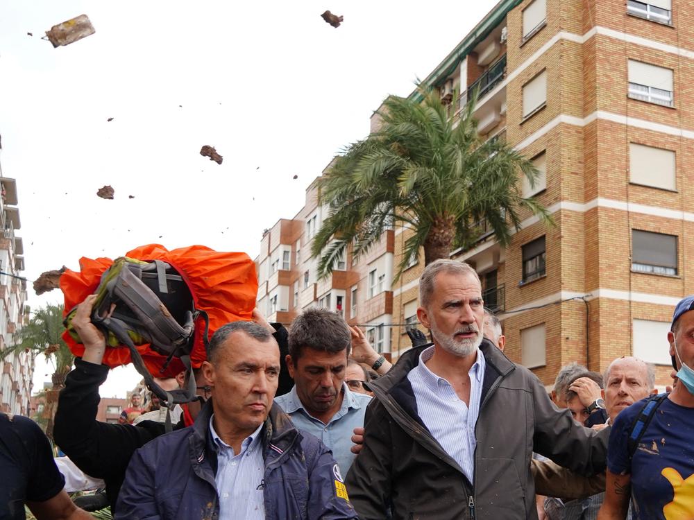 King Felipe VI of Spain is heckled by angry residents who throw mud and objects during his visit to Paiporta, in the region of Valencia, eastern Spain, on November 3, 2024, in the aftermath of devastating deadly floods.