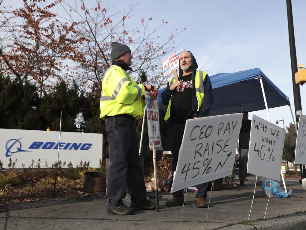 Striking machinists at Boeing picket outside the company's Renton Production Facility in Washington. Some 33,000 workers walked off the job in September demanding higher pay and better retirement benefits. Union members voted down two previous contract offers from Boeing ahead of Monday's vote to accept the new proposal from the company.