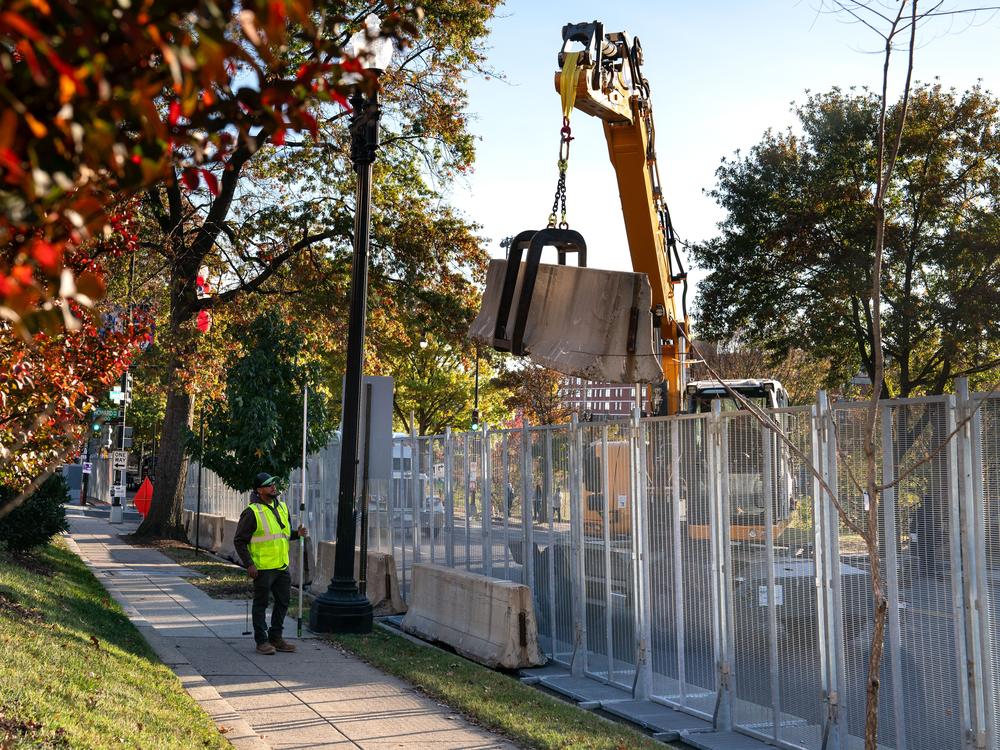 Workers erect anti-scale fencing and other security measures around Howard University on Sunday in Washington, D.C. Democratic nominee Vice President Kamala Harris will spend election night at her alma mater.