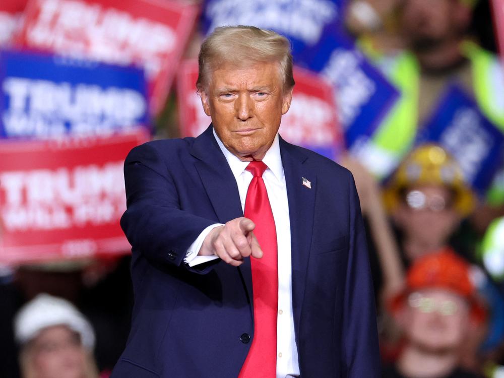 Former President and Republican presidential candidate Donald Trump gestures during a campaign rally in Pittsburgh, Pa., on Monday, the night before Election Day.