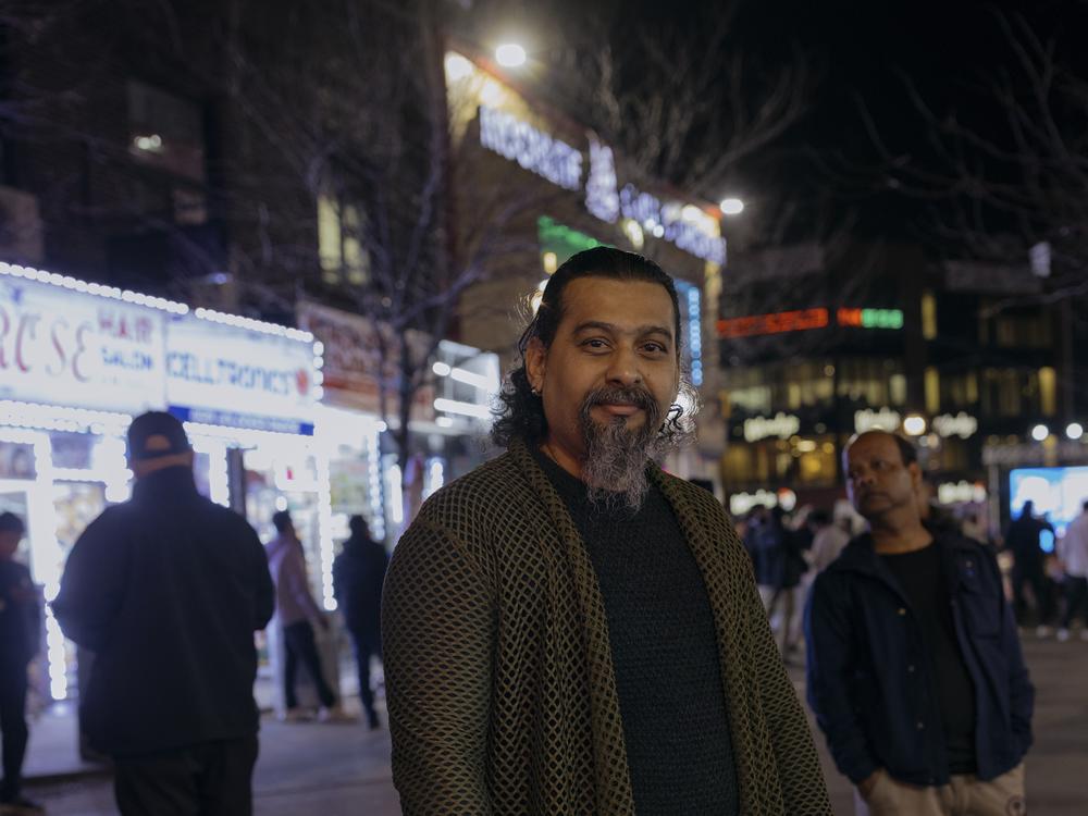 Amen Kahn, 56, a 12-year resident of the Jackson Heights neighborhood, stands for a portrait in Diversity Plaza on Tuesday.
