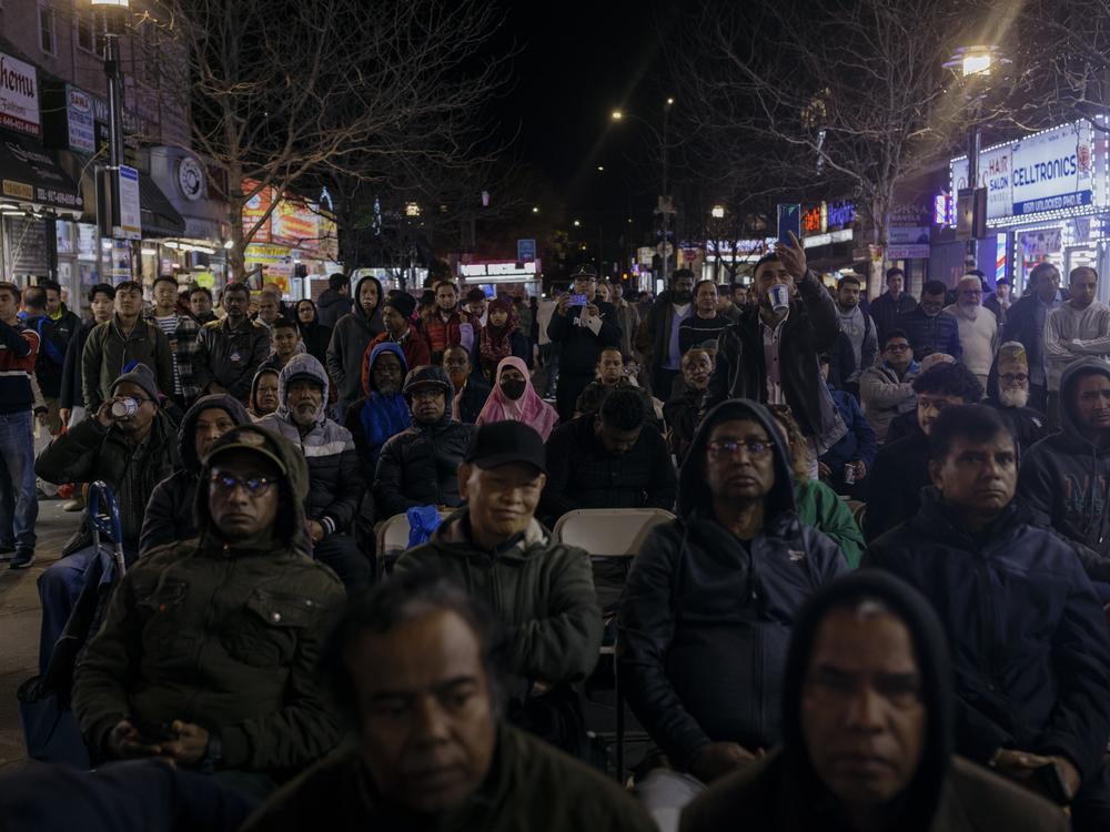 Residents of the Jackson Heights neighborhood anxiously look on for the evening's election results during an election night watch party in Diversity Plaza.