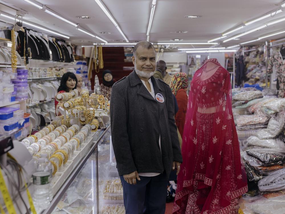 Mithu Ahmed, 60, a local business owner in Jackson Heights, stands for a portrait inside his store in Diversity Plaza.
