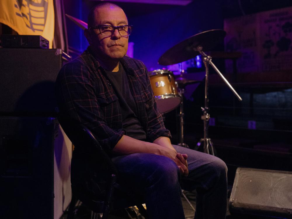Freddy Castiblanco, 53, sits for a portrait at his music club, Terraza 7.