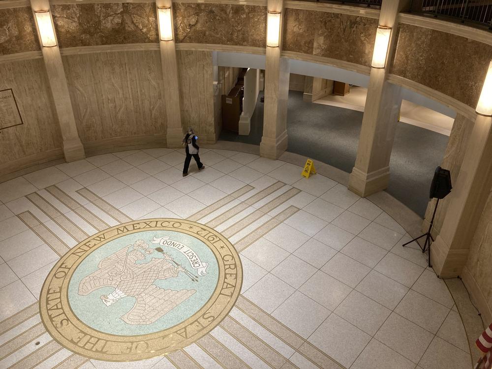 A pedestrian traverses the rotunda in the New Mexico state Capitol building in Santa Fe, N.M.