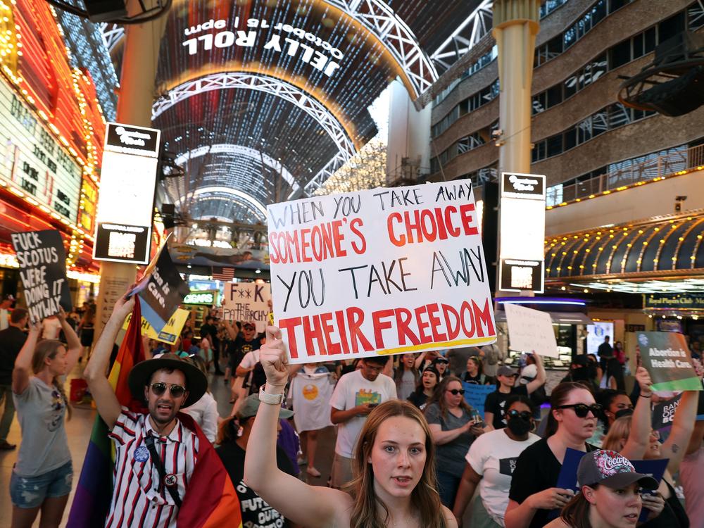 Abortion rights activists march along Fremont Street Experience as they protest the overturning of Roe Vs. Wade by the US Supreme Court, in Las Vegas, Nevada on June 24, 2022.