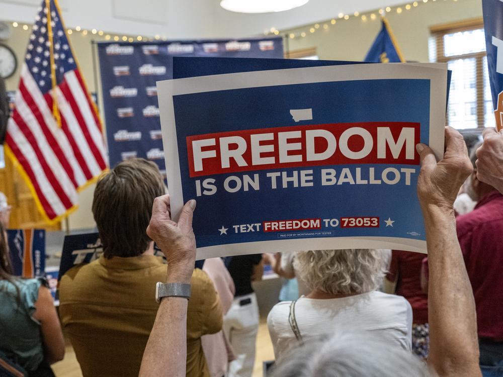 Signs supporting the abortion rights amendment are displayed during a rally on September 5, 2024 in Bozeman, Mont.