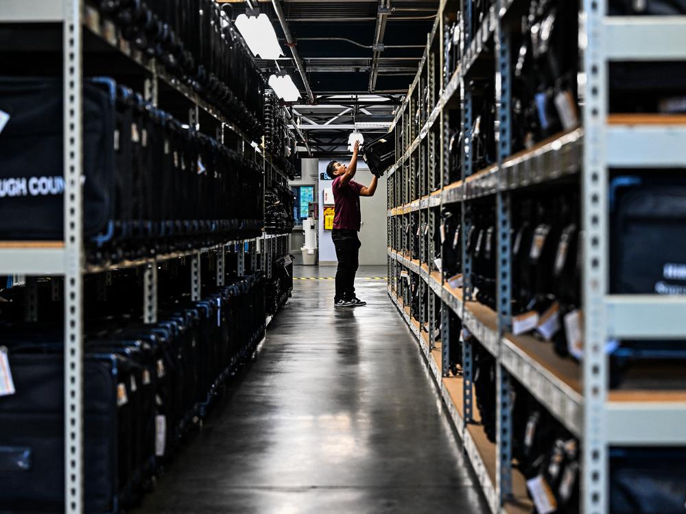 An election office worker moves bags of election supplies at the Robert L. Gilder Elections Service Center in Tampa, Florida, on November 2, 2024.