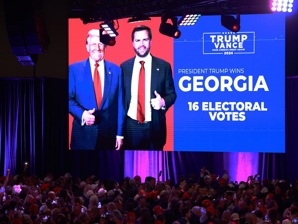 Supporters watch as Georgia is called for Donald Trump during an election night watch party at the Palm Beach Convention Center.