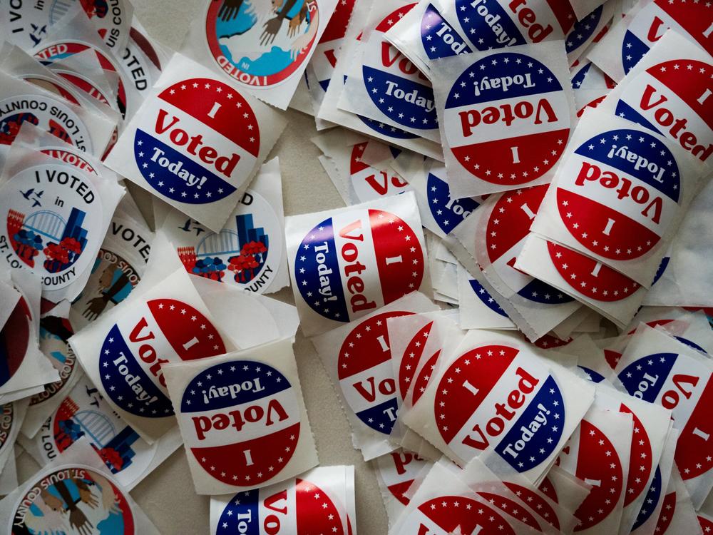 St. Louis County voting stickers are laid out for voters at Holy Name Community Center in Bellefontaine Neighbors, Mo.