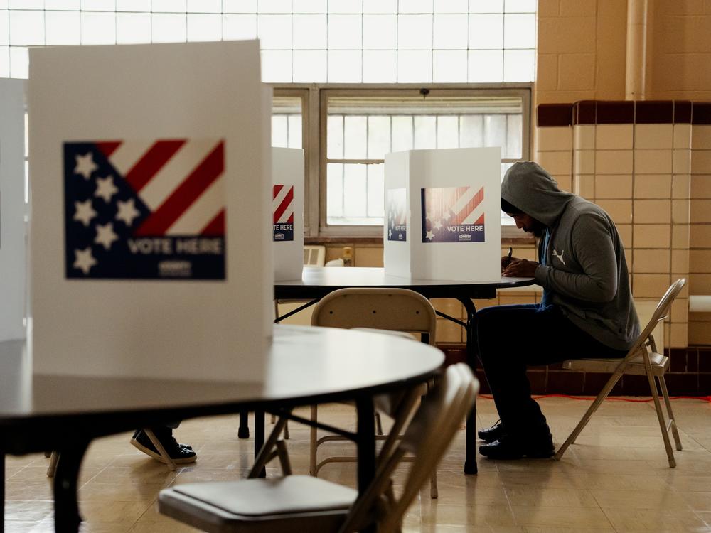 Adam Powell, 45, casts his ballot during the General Election at Holy Name Community Center in Bellefontaine Neighbors, Mo. A power outage at the polling site caused staff to run off of lanterns and generators.