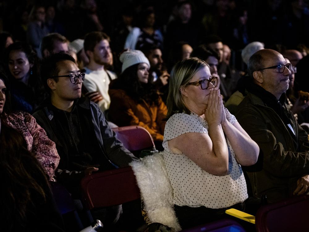 A crowd watches election results on Valencia Street near Manny’s in San Francisco on Tuesday.