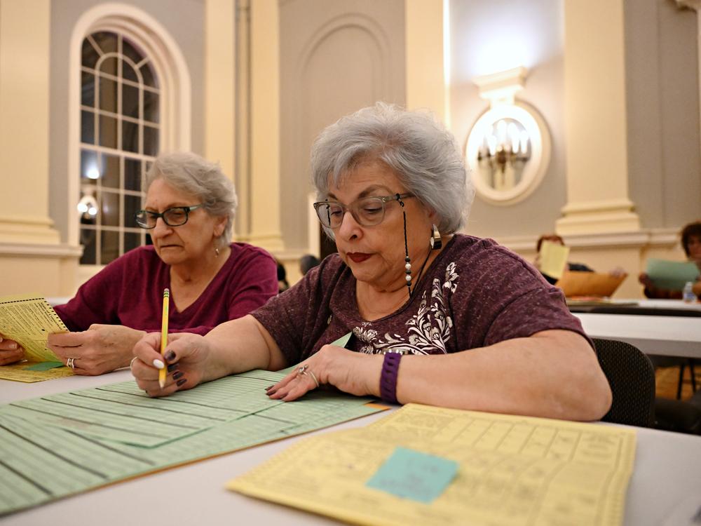 At Waterbury City Hall, Joanna Dvorchak (left) and Rosemary Delano (right) hand count ballots that didn’t read in the tabulator machine the evening of Election Day in Waterbury, Conn.