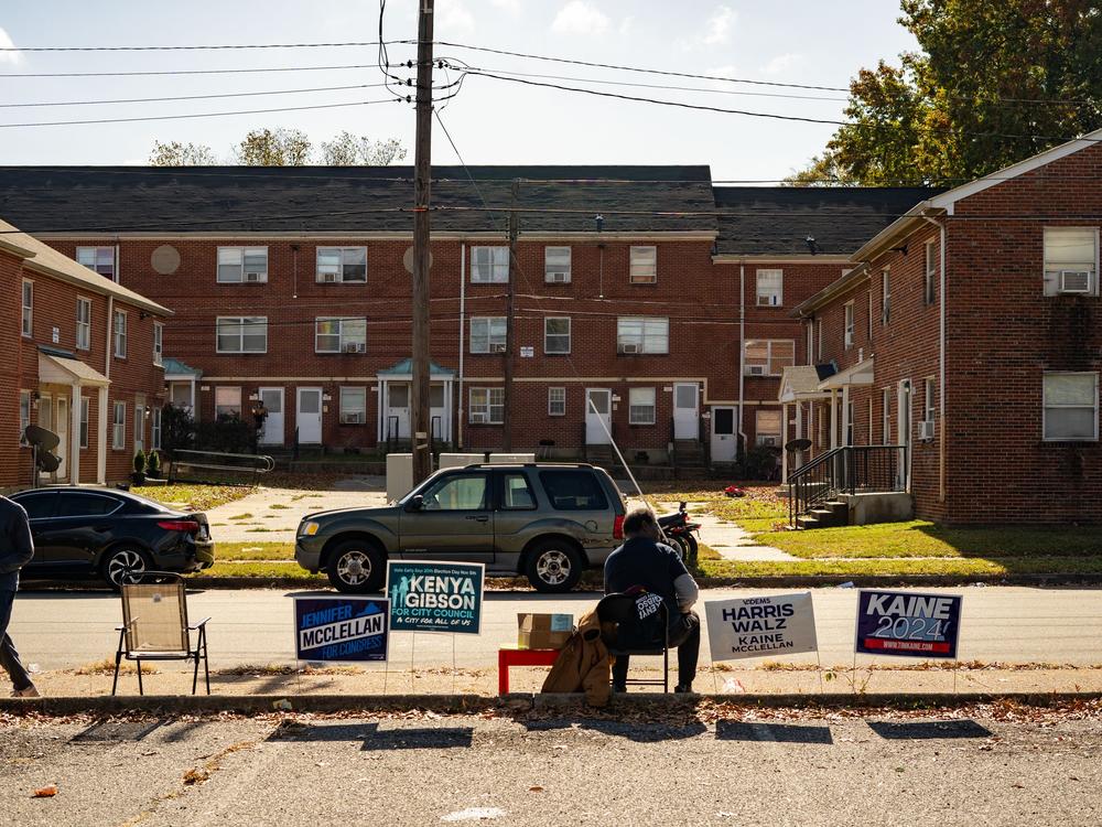 Voters arrive at Calhoun Community Center on Election Day morning to cast their ballots, with poll workers assisting with check-in and directions in Richmond, Va.
