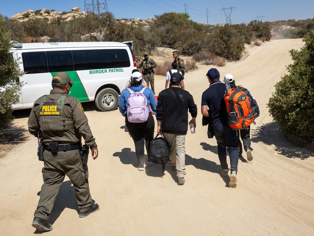 U.S. Border Patrol agents take asylum-seekers into custody after they crossed a remote area of the U.S.-Mexico border near Jacumba Hot Springs, Calif., on Sept. 19. Trump's plan for mass deportations, if carried out, could deprive the economy of needed workers.