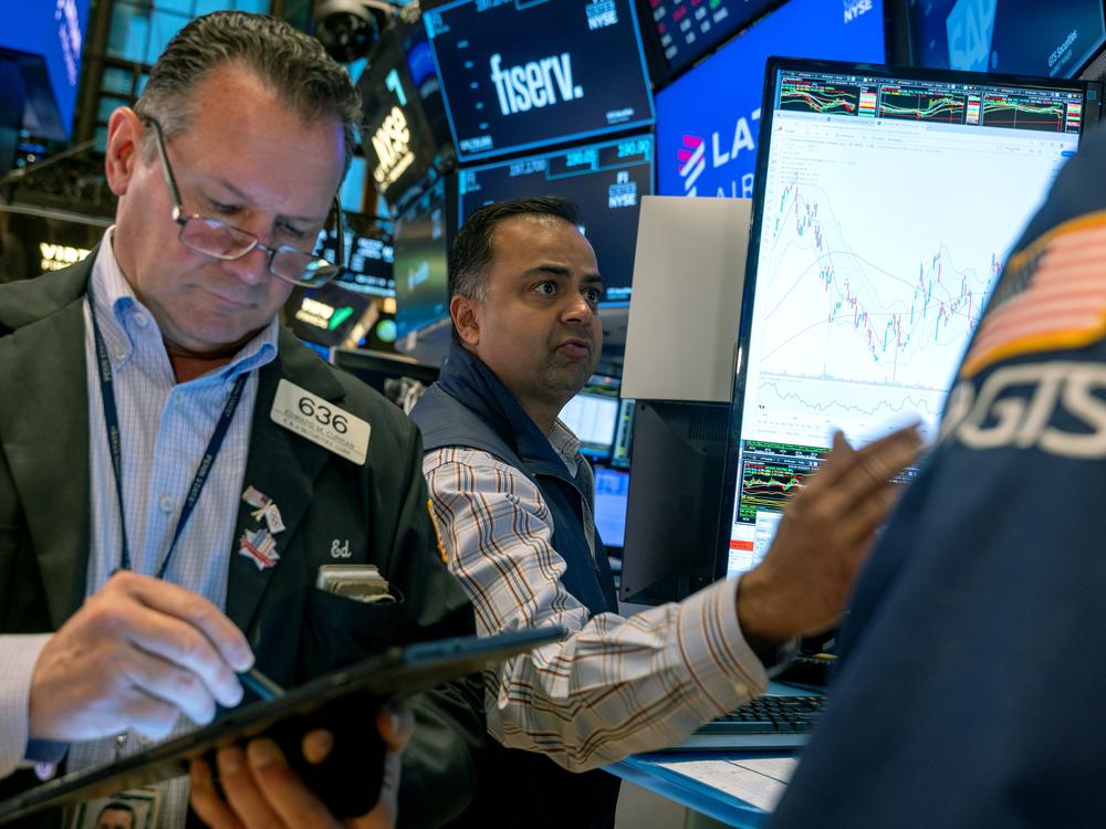 Stocks and cryptocurrencies surged after former President Trump won the presidential election. Pictured are traders working on the New York Stock Exchange in New York on Oct. 22.