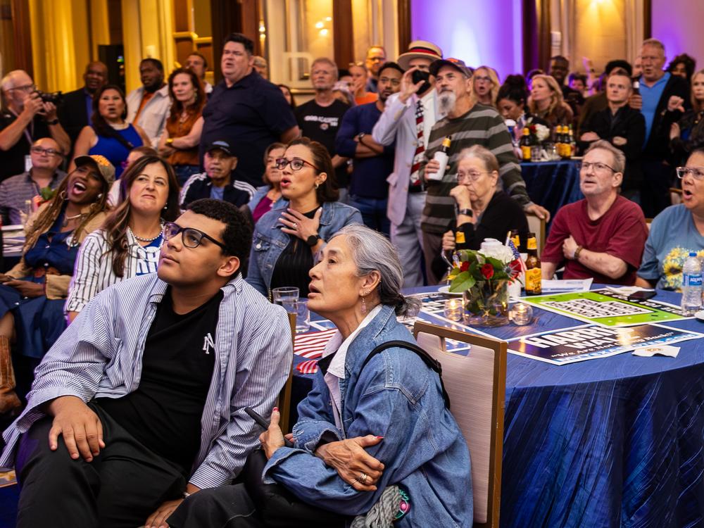 Attendees react as a race is predicted for Trump during the Travis County Democratic Party’s Election Night watch party in Austin, Texas.