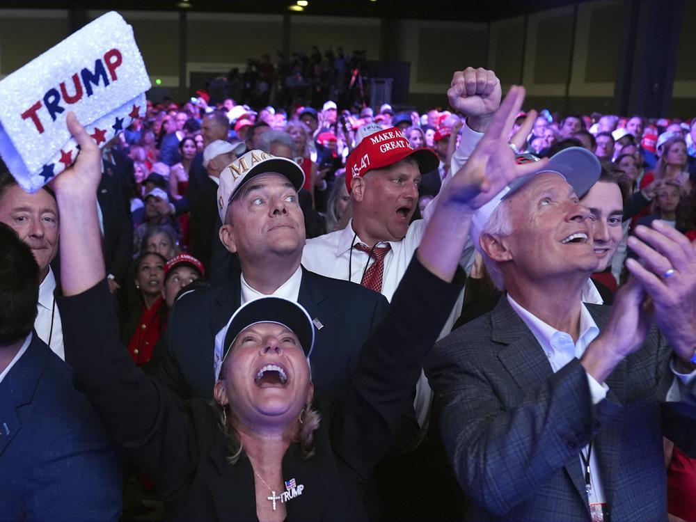 Supporters watch returns at a campaign election night watch party for Republican presidential nominee former President Donald Trump at the Palm Beach Convention Center.