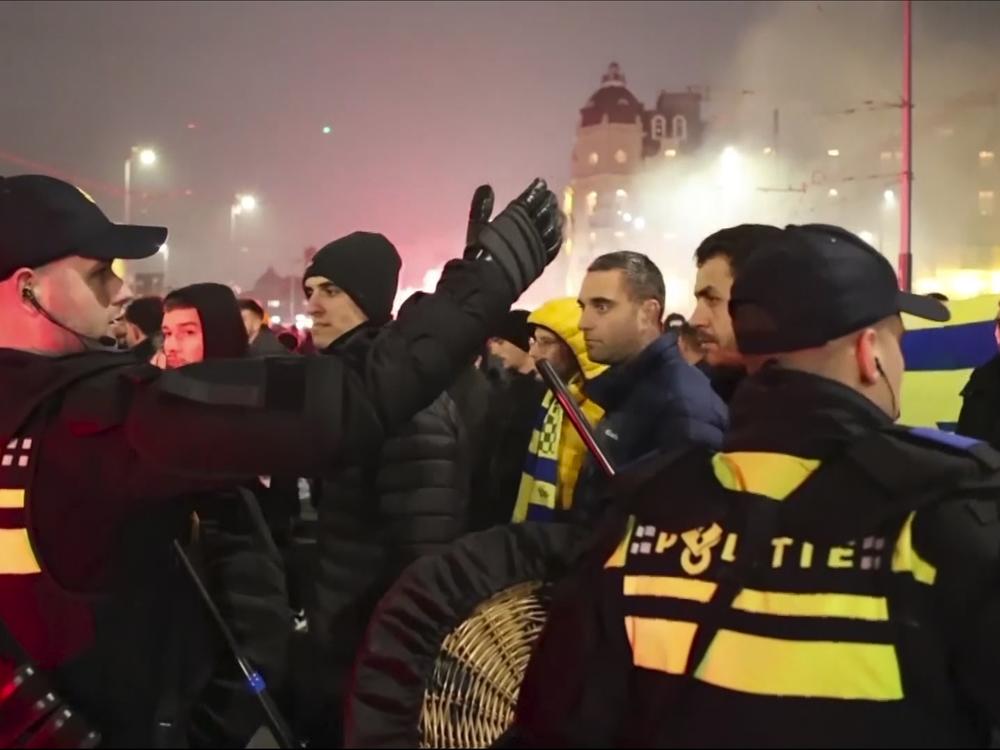 In an image taken from video, police are seen escorting Maccabi Tel Aviv soccer team supporters to the metro station, leading them to the Ajax stadium, after pro-Palestinian supporters marched near the stadium, in Amsterdam, Thursday.