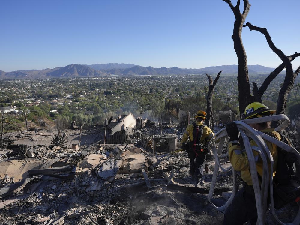 Los Angeles Fire Department firefighters work at a home destroyed by the Mountain Fire in Camarillo, Calif. on Friday.