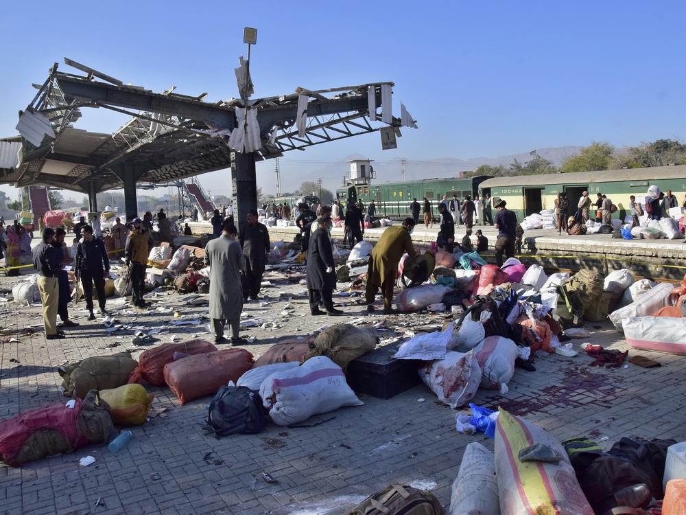Security officials examine the site of a bomb explosion at railway station in Quetta, southwestern Pakistan on Saturday.