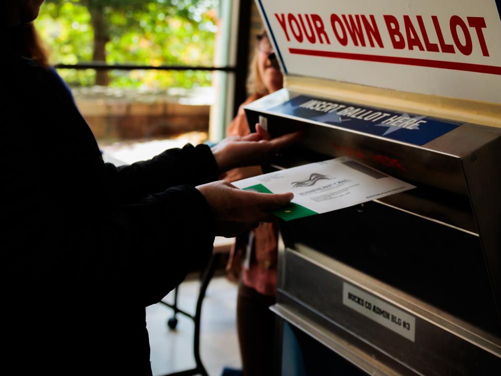 A person drops off a mail-in ballot in October in Doylestown, Pa. Pennsylvania county officials received thousands of last-minute challenges to voters’ absentee ballot applications, most of which were withdrawn shortly after Election Day.