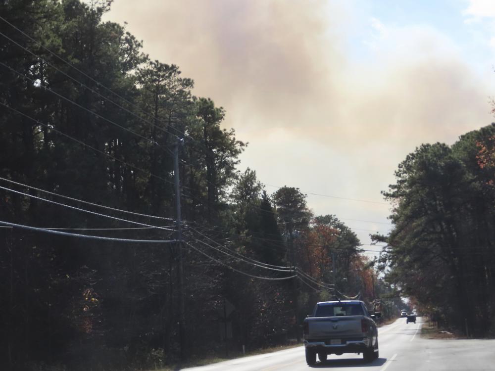Smoke from a forest fire rises above the trees in Evesham, N.J. on Thursday, Nov. 7, 2024, when firefighters said conditions were the driest in New Jersey in nearly 120 years.
