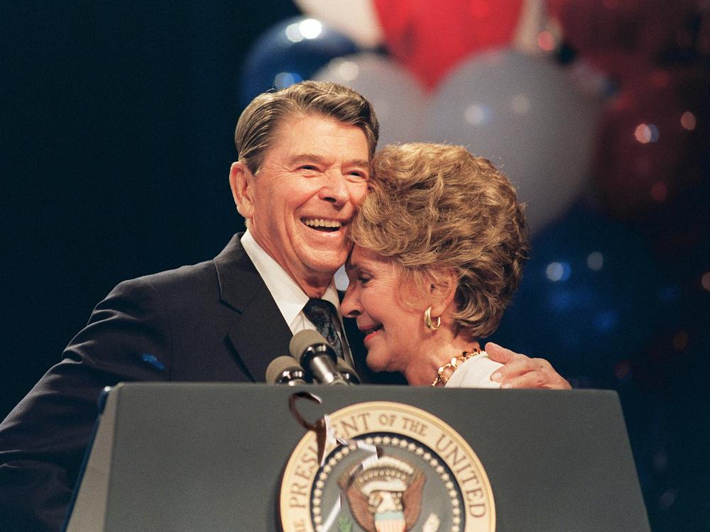 Former first Lady Nancy Reagan rests her head against her husband, Former President Ronald Reagan, as he praised her during a luncheon in New Orleans on August 15, 1988.