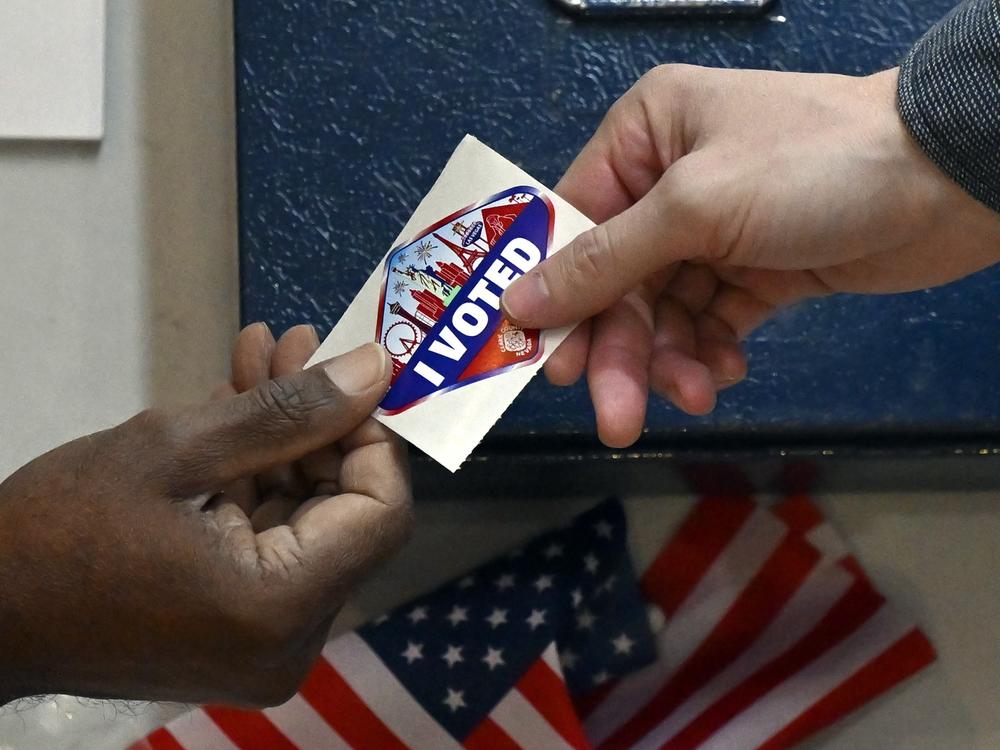 A voter receives a Las Vegas-themed 