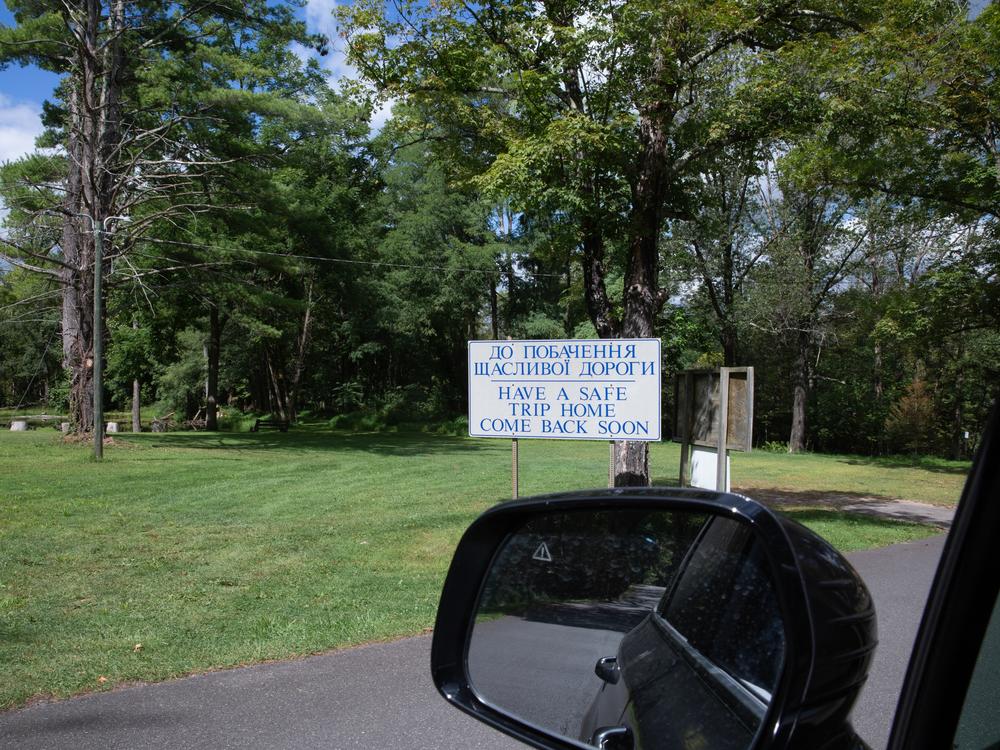 The Ukrainian text on a big sign that bids visitors farewell reads “Goodbye and have a nice trip.”