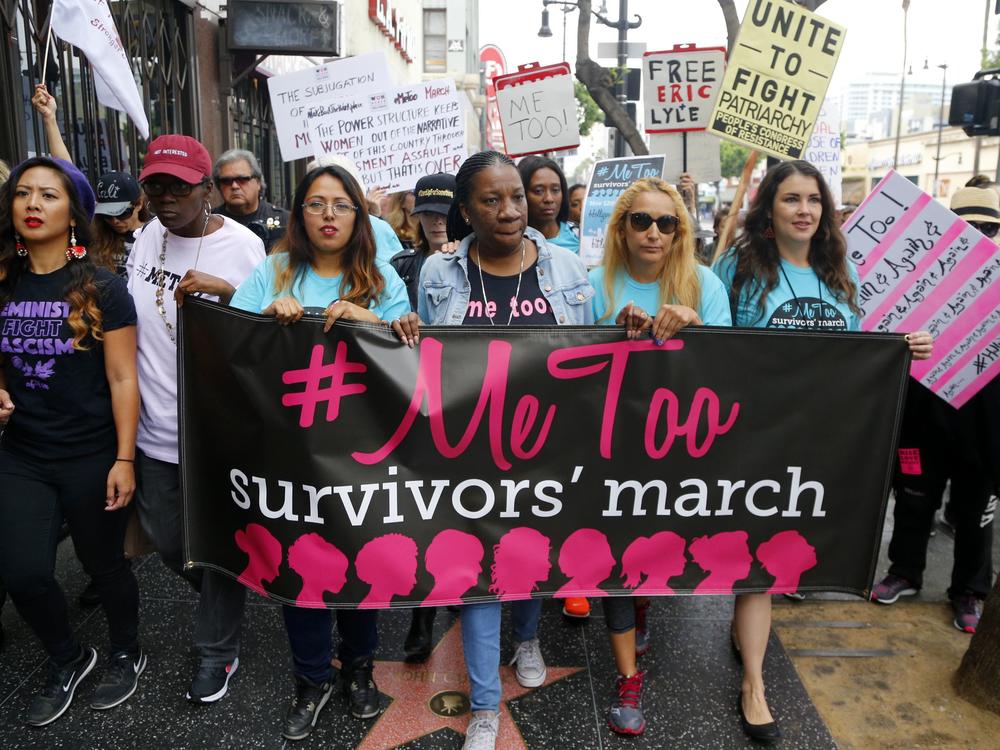 In this 2017, file photo, Tarana Burke (center), founder and leader of the #MeToo movement, marches with others at the #MeToo March in the Hollywood section of Los Angeles.
