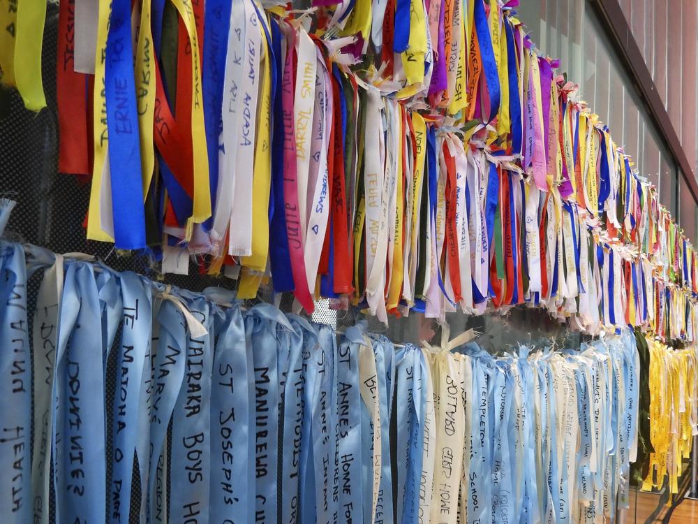 Ribbons are displayed on a wall at Parliament House in Wellington, New Zealand, ahead of the apology to the survivors of abuse in state, faith-based and foster care over a period of seven decades.