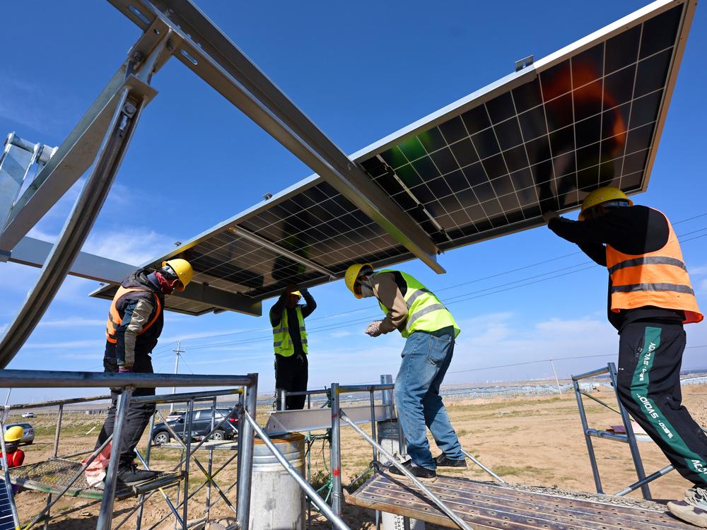 Workers install solar panels in China's northern Ningxia region.