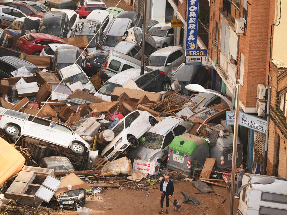 Cars are piled in the street with other debris in Valencia, Spain, after flash floods in October. Scientists with a group called World Weather Attribution said in a rapid analysis that the flooding was caused by intense rainfall that was 12% heavier and twice as likely due to climate change.