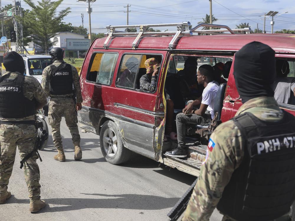 Police officers patrol near the Toussaint Louverture International Airport in Port-au-Prince, Haiti on Tuesday.