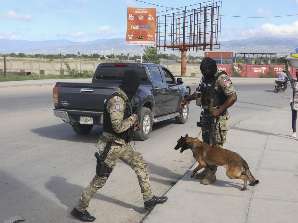 Police officers patrol near the Toussaint Louverture International Airport in Port-au-Prince, Haiti on Tuesday.