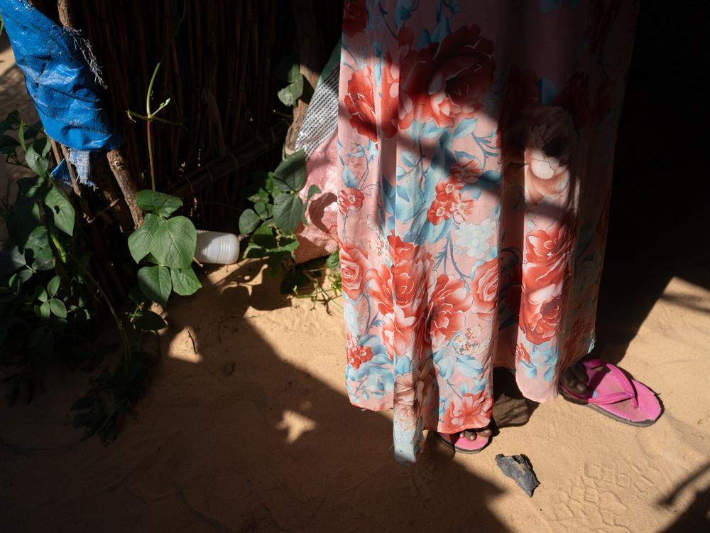 Entesar, a college student who was studying computer science before the war, stands in the kitchen in the tent where she is staying in Adre refugee camp.