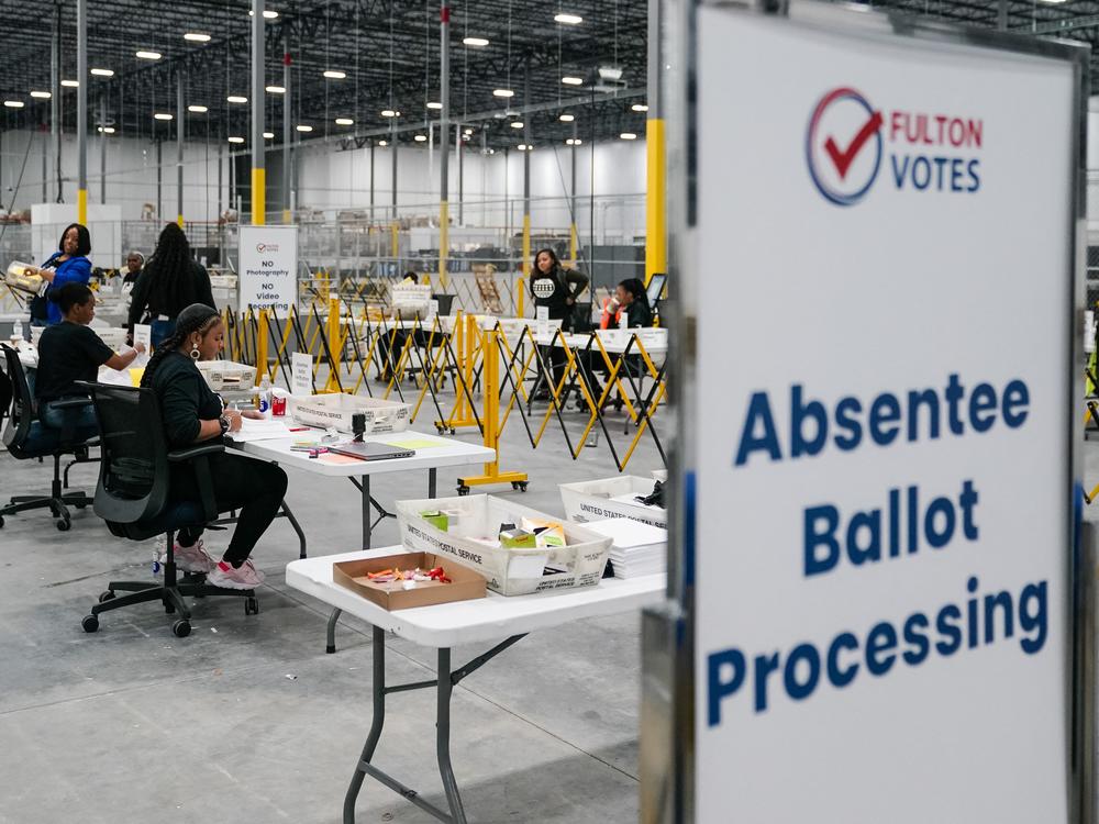 Fulton County election workers process absentee ballots on Nov. 4, in Union City, Ga.
