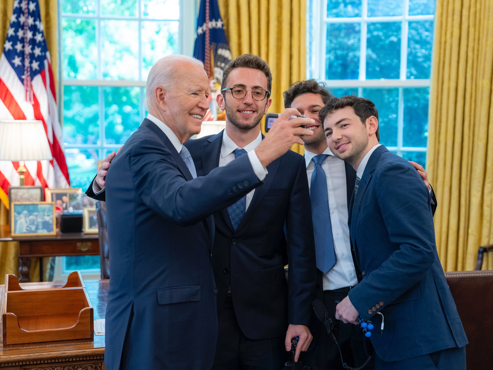 Christian Baiocco, Griffin Katz and Grant Weintrob pose for a film photo with President Joseph Biden.