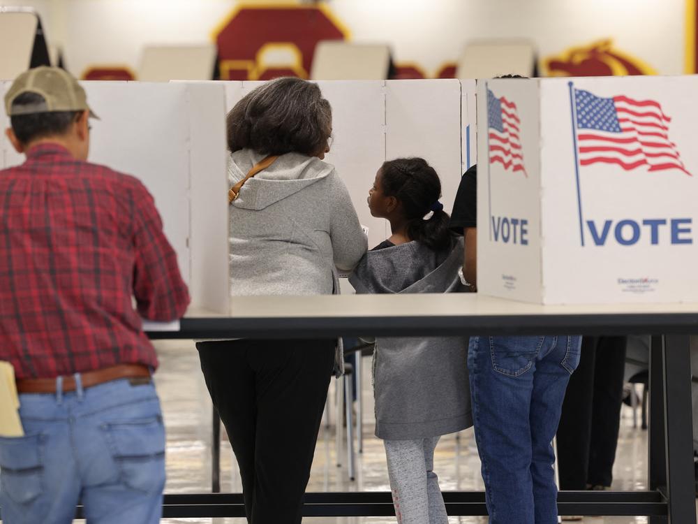 Voters gather at polling station in Oakton, Va., on Nov. 5. Parents are grappling with how to talk to their children about the election.
