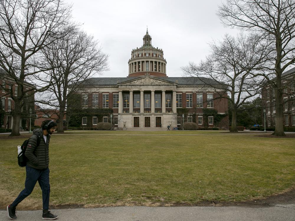 Students walk by the Rush Rhees Library at the University of Rochester on Feb. 22, 2023.