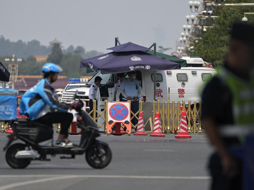 Security officers stand watch at a road near Tiananmen Square in Beijing, June 4, as China heightened security for the 35th anniversary of a bloody crackdown on pro-democracy protests there.