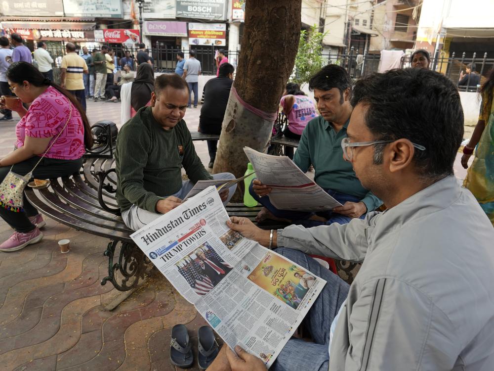 People read U.S. election news at a roadside tea shop in Lucknow, India, on Nov. 7.
