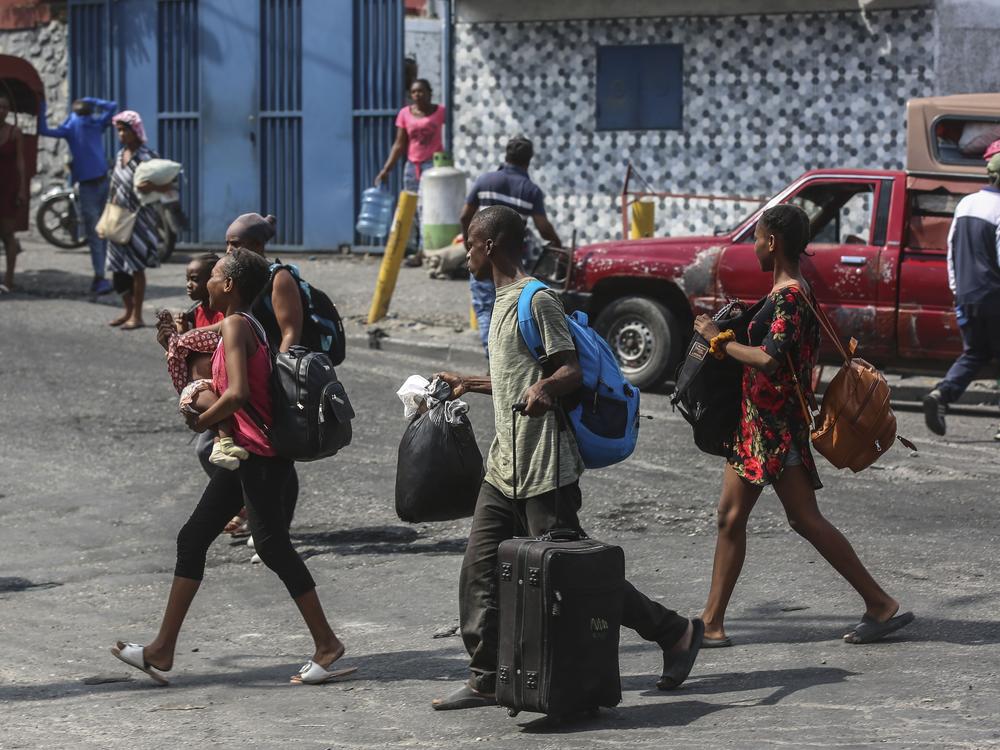 Residents flee their homes to escape gang violence in the Nazon neighborhood of Port-au-Prince, Haiti on Thursday.